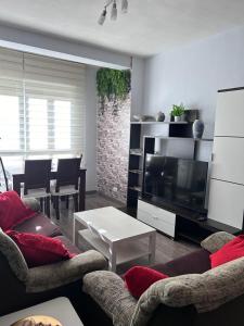 a living room with couches and a flat screen tv at Los Soportales in Soria