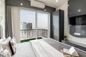 a bedroom with a bed and a large window at Kaveri Studio Apartment near India Expo Centre in Greater Noida