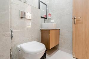 a bathroom with a toilet and a sink at Kaveri Studio Apartment near India Expo Centre in Greater Noida +18 photos