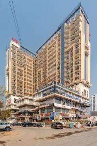 a large building with cars parked in front of it at Kaveri Studio Apartment near India Expo Centre in Greater Noida