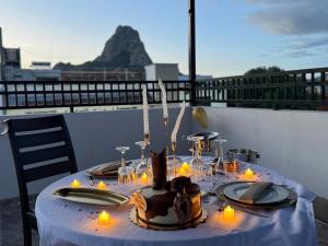 a table with candles and a cake on a balcony at Casa Alejandra, Bernal Pueblo Magico in Bernal