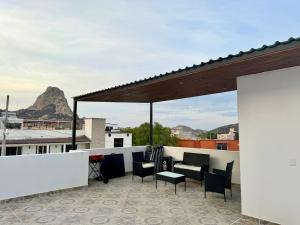 a patio with chairs and a table on a roof at Casa Alejandra, Bernal Pueblo Magico in Bernal