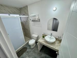 a bathroom with a toilet and a sink and a shower at Casa Alejandra, Bernal Pueblo Magico in Bernal