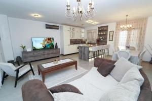 a living room with a couch and a tv in it at KLM holiday home in Rupalj