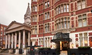 a large red brick building next to a building at Thistle London Holborn in London +33 photos