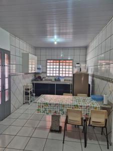 a kitchen with a table and chairs in a room at Chalé dos Marques in Caldas Novas