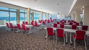 a conference room with tables and chairs and the ocean at Royal Ariston Hotel in Dubrovnik +88 photos