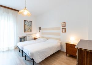 two beds in a room with white walls at Mountain Paradise - Luminoso e ampio con vista in Serina