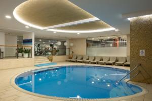 a large swimming pool in a hotel lobby at Royal Palm Hotel in Dubrovnik