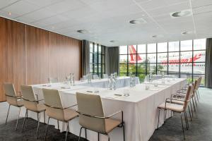 a large conference room with a long table and chairs at Corendon Urban Amsterdam Schiphol Airport Hotel in Badhoevedorp
