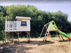 a playground with a slide and a play structure at La Dilettante - petit déjeuner inclus - 10mn du Parc in Treize-Vents