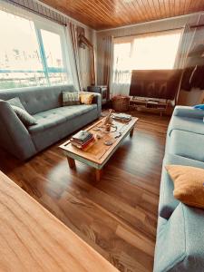 a living room with a couch and a coffee table at Refugio Ballena Hostel in Castro