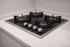 a stove top with four burners on a counter at Art Apartments Karbala in Karbala