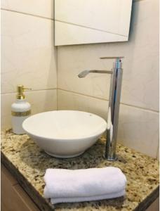 a bathroom with a white bowl sink on a counter at Hotel Boutique 1970 in Asunción