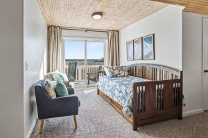 a bedroom with a bed and a chair and a window at Harbor Island 49 Nautical Watch in Fripp Island +42 photos
