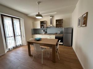 a kitchen with a table and chairs in a room at B&b DALLA FE in Fermignano