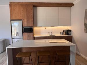a kitchen with a island with two bar stools at The Shirley in Gqeberha