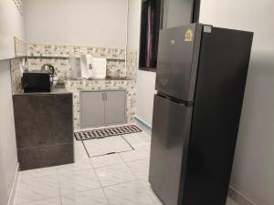 a kitchen with a stainless steel refrigerator in a room at Sea heaven Phuket Naiyang in Phuket