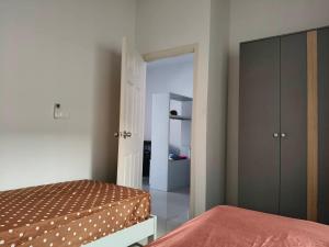 a bedroom with a bed and a closet at Sea heaven Phuket Naiyang in Phuket