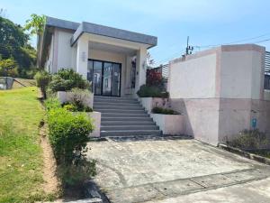 a house with stairs leading to a door at Sea heaven Phuket Naiyang in Phuket +1 photo