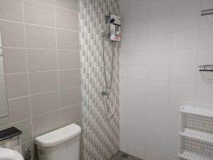 a bathroom with a shower with a toilet in it at Sea heaven Phuket Naiyang in Phuket