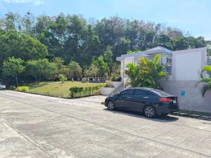 a black car parked in front of a house at Sea heaven Phuket Naiyang in Phuket