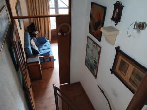 a hallway with a stairway with paintings on the wall at Gozo Duplex Studio overlooking historic Piazza in Victoria