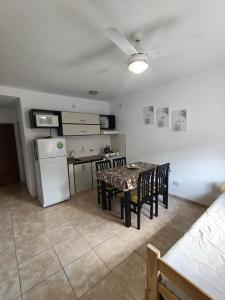 a kitchen with a table and chairs and a refrigerator at Departamento Marusa in Gualeguaychú +10 photos