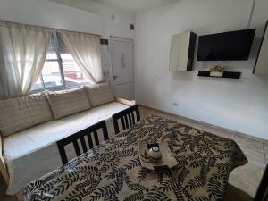 a bedroom with a bed with a black and white blanket at Departamento Marusa in Gualeguaychú