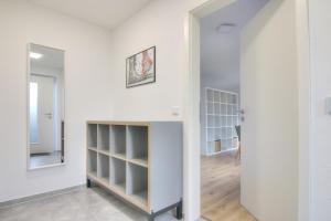 a room with white walls and a closet with shelves at Modernes Wohlfühl-Apartment mit Glasfaser-WLAN, Parkplatz in der Nähe & Küche in Bad Wimpfen in Bad Wimpfen