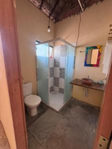 a bathroom with a shower and a toilet and a sink at Vila Macapaz Kitesurf in Luis Correia +24 photos