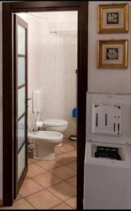 a bathroom with a white toilet and a sink at Va Pensiero Cuore di Parma in Parma