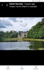 a picture of a lake with a building in the background at HomefromHome in Rosslare