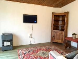 a living room with a flat screen tv on a wall at Lagomar Casa tipo loft in Ciudad de la Costa