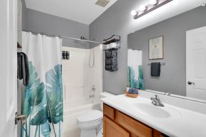 a bathroom with a sink and a toilet and a shower at Kindroot 5 in Tucson