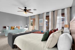a bedroom with a bed and a ceiling fan at Kindroot 5 in Tucson
