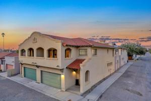 a large house with a sunset in the background at Kindroot 5 in Tucson