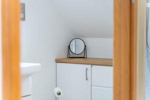 a mirror sitting on top of a counter in a bathroom at Ben View Room 3 in Fort William