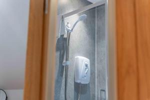 a shower with a soap dispenser in a bathroom at Ben View Room 3 in Fort William