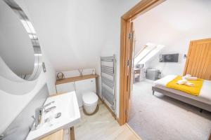 a bathroom with a bed and a sink in a room at Ben View Room 3 in Fort William