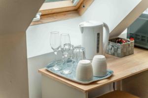 a counter with wine glasses and plates on it at Ben View Room 3 in Fort William +5 photos