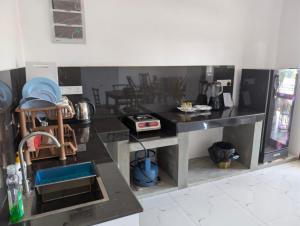 a kitchen with a black counter top in a room at The Aurora in Ahangama +9 photos