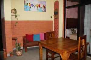 a living room with a wooden table and a couch at Welcome Inn in Ella +43 photos