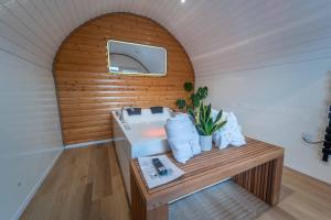 a small room with a sink and a wooden wall at Apex Studio Pod and Jacuzzi Bath in Fort William