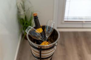 a bottle of wine in a bucket on a table at Ben View Room and Jacuzzi Bath in Fort William