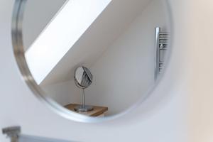 a mirror reflection of a lamp on a table at Ben View Room 4 in Fort William