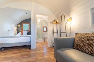 a bedroom with a bed and a couch in a room at Ben View Pod and Jacuzzi Bath in Fort William