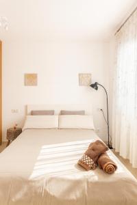 a bedroom with a large white bed with a blanket at Can Angelica in Santa Margalida +17 photos