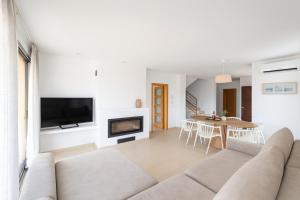 a living room with a couch and a fireplace at Can Angelica in Santa Margalida