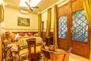 a bedroom with a bed and a window at Riad Habouba in Marrakesh
